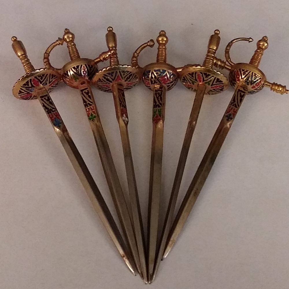 3 in. Swords an stand. All made of metal. Unique.